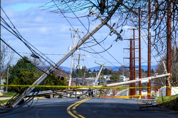 Power lines are down Tuesday, March 17, 2026, along South 12th Street in Allentown after Monday night's strong winds. Storms blew off roofs and downed trees and power lines around the Lehigh Valley, leaving thousands without electricity. (April Gamiz/The Morning Call)