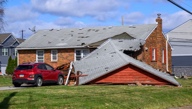 Storm damage from Monday night's strong winds is seen Tuesday, March 17, 2026, at a house on Devonshire Road in Allentown. Storms blew off roofs and downed trees and power lines around the Lehigh Valley, leaving thousands without electricity. (April Gamiz/The Morning Call)