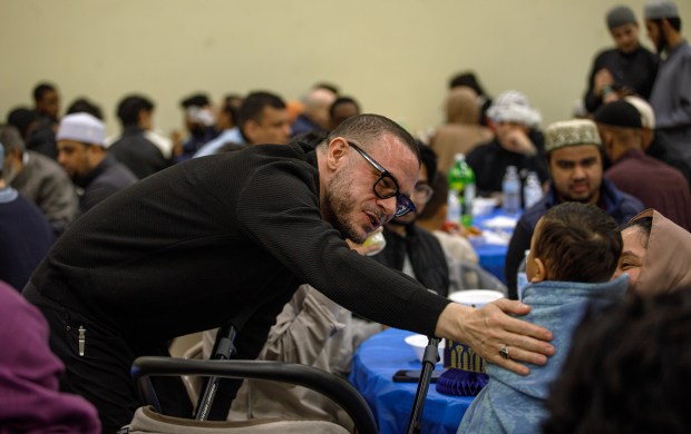 Activist and author Shaun King speaks to a child prior to speaking at the third annual Lehigh Valley Community Iftar on Sunday, March 8, 2026, at the Muslim Association of the Lehigh Valley in Whitehall Township. The iftar, centered on the theme of "pray for peace," was organized by two Lehigh Valley families, the Mughal and Mohammad families. They expected more than 1,000 participants from diverse backgrounds for the ceremonial meal Muslims hold to mark the end of daily fasting during Ramadan. (Jane Therese/Special to The Morning Call)