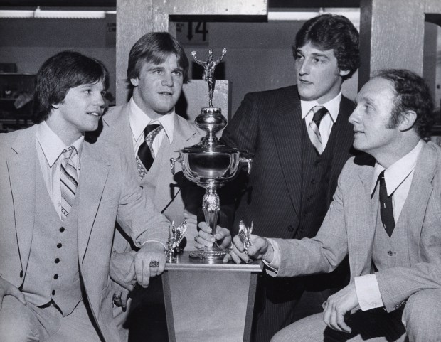 The Dieruff football team went undefeated in 1979. Dieruff players and captains Rich Gimbor, Dave Kurisco, and Rich Sniscak, and Coach Bruce Trotter celebrate with city championship trophy at a banquet. (Morning Call File Photo).
