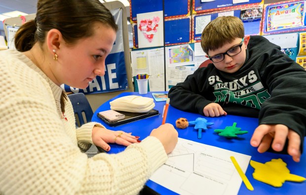Moravian University student Lillian Driscoll engages with third grader Jaxon B. on Monday, March 2, 2026, at William Penn Elementary School in Bethlehem, where Moravian University students are running a story workshop for third graders. The university students, part of Moravian's art and child development education course, are using puppets to engage the third graders in shaping characters and themes for original children's books. (April Gamiz/The Morning Call)