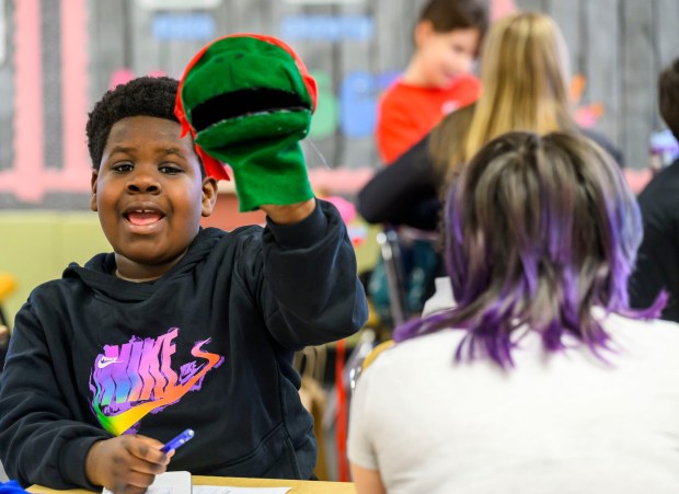 Moravian University student Emari Mindler engages with third grader Kahari B. on Monday, March 2, 2026, at William Penn Elementary School in Bethlehem, where Moravian University students are running a story workshop for third graders. The university students, part of Moravian's art and child development education course, are using puppets to engage the third graders in shaping characters and themes for original children's books. (April Gamiz/The Morning Call)