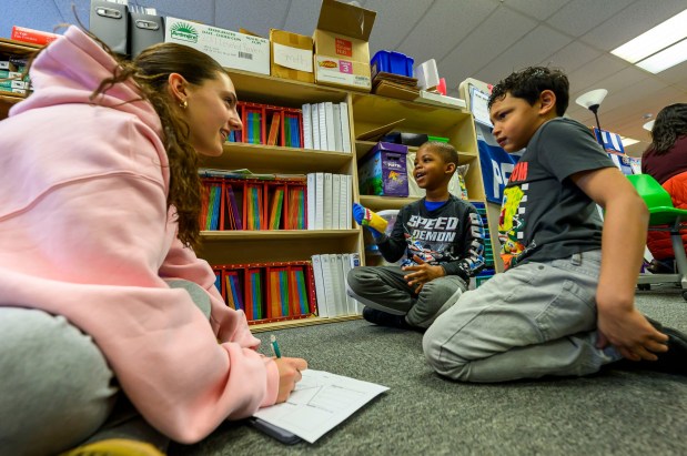 Moravian University student Siria Moretti engages with third graders Julian J. and Yamoussa T. on Monday, March 2, 2026, at William Penn Elementary School in Bethlehem, where Moravian University students are running a story workshop for third graders. The university students, part of Moravian's art and child development education course, are using puppets to engage the third graders in shaping characters and themes for original children's books. (April Gamiz/The Morning Call)