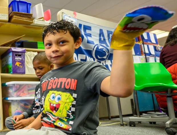 Moravian University student Siria Moretti engages with third graders Julian J. and Yamoussa T. on Monday, March 2, 2026, at William Penn Elementary School in Bethlehem, where Moravian University students are running a story workshop for third graders. The university students, part of Moravian's art and child development education course, are using puppets to engage the third graders in shaping characters and themes for original children's books. (April Gamiz/The Morning Call)