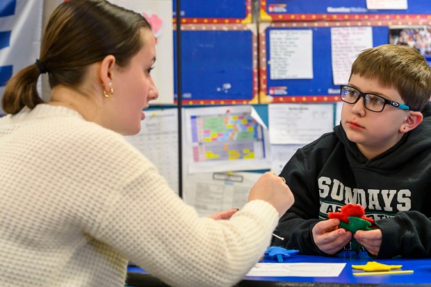 Moravian University student Lillian Driscoll engages with third grader Jaxon B. on Monday, March 2, 2026, at William Penn Elementary School in Bethlehem, where Moravian University students are running a story workshop for third graders. The university students, part of Moravian's art and child development education course, are using puppets to engage the third graders in shaping characters and themes for original children's books. (April Gamiz/The Morning Call)