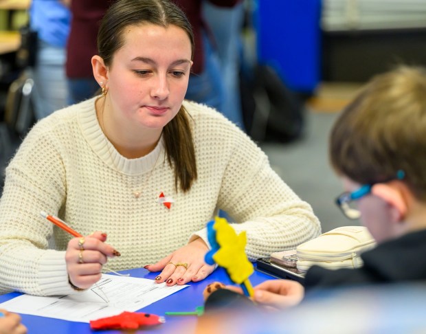 Moravian University student Lillian Driscoll engages with third grader Jaxon B. on Monday, March 2, 2026, at William Penn Elementary School in Bethlehem, where Moravian University students are running a story workshop for third graders. The university students, part of Moravian's art and child development education course, are using puppets to engage the third graders in shaping characters and themes for original children's books. (April Gamiz/The Morning Call)