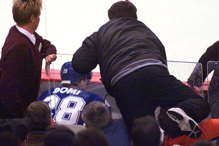 Flyers fan Chris Falcone jumps from his seat in the second row over the glass behind the penalty box, prompting a famous brawl with Toronto Maple Leafs enforcer Tie Domi in 2001.