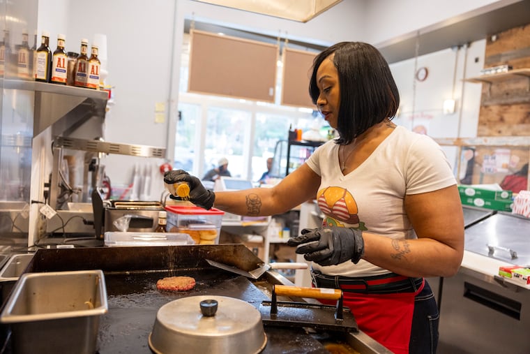 Mia Robertson, owner of Bikini Burger, makes a cheeseburger at Bikini Burger in Ardmore, Pa.