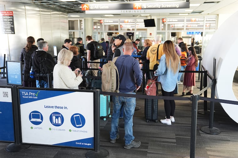 Travelers stand in line at a TSA screening area at Philadelphia International Airport in November.