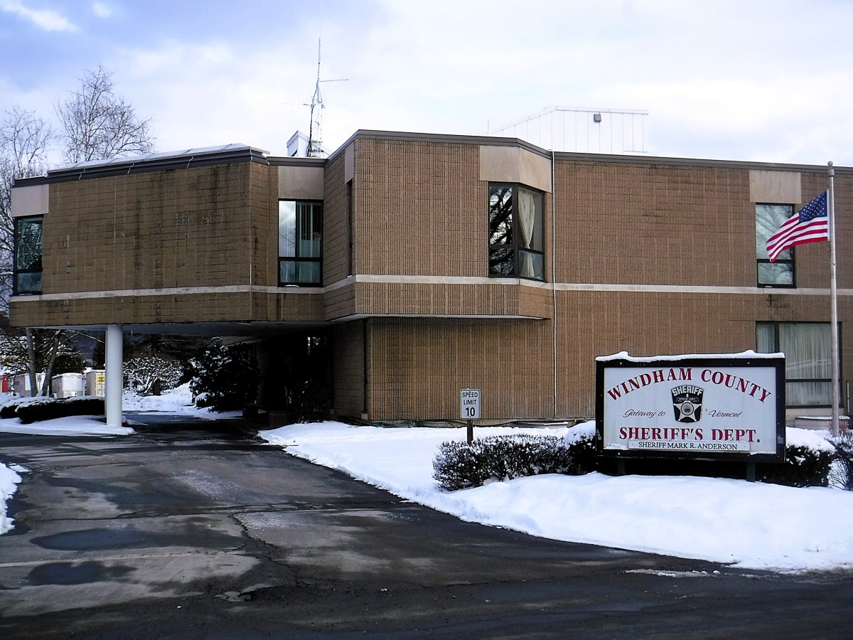 A large brown building on a snowy winter day.