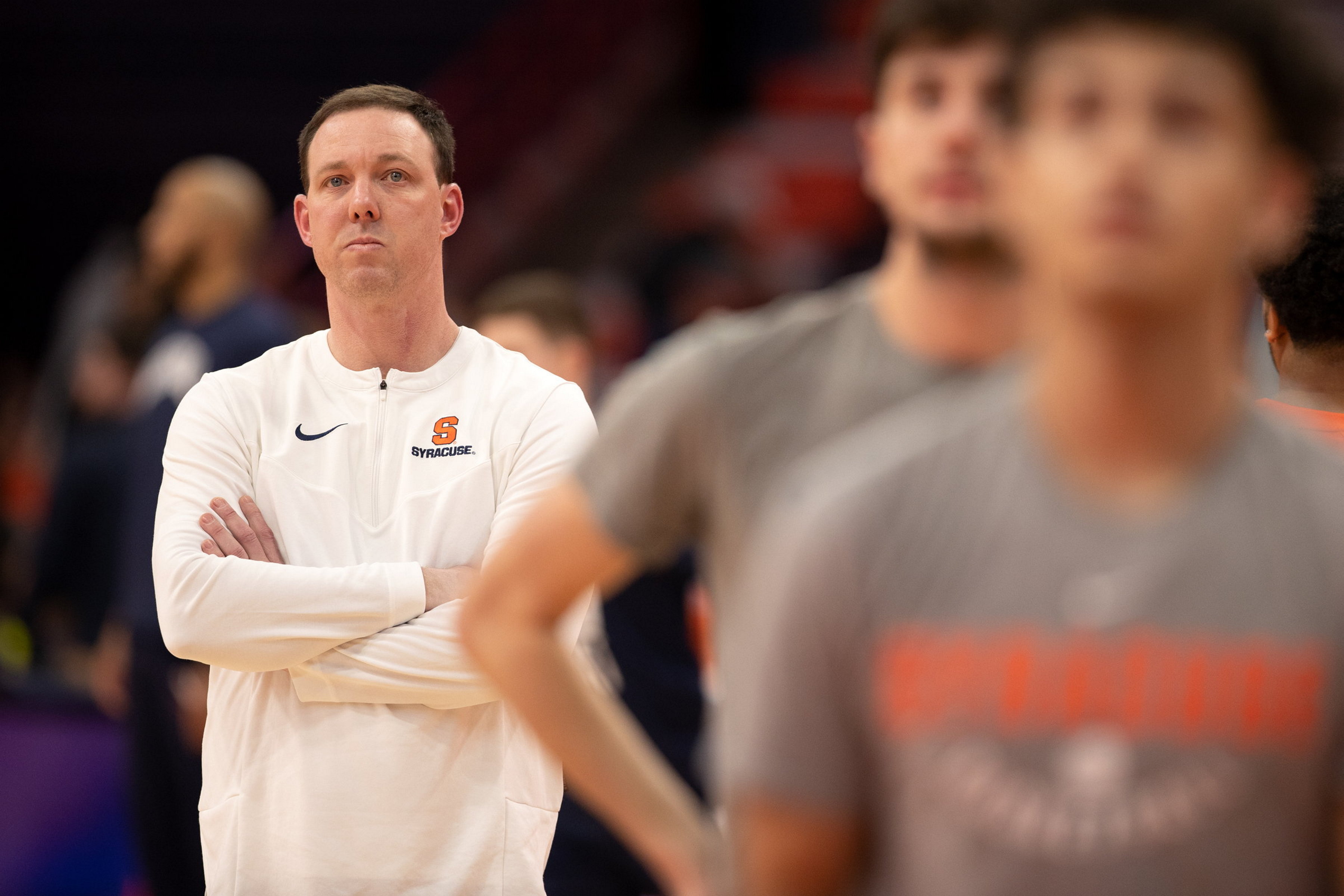 Syracuse men’s basketball assistant coach Gerry McNamara watches warmups before...