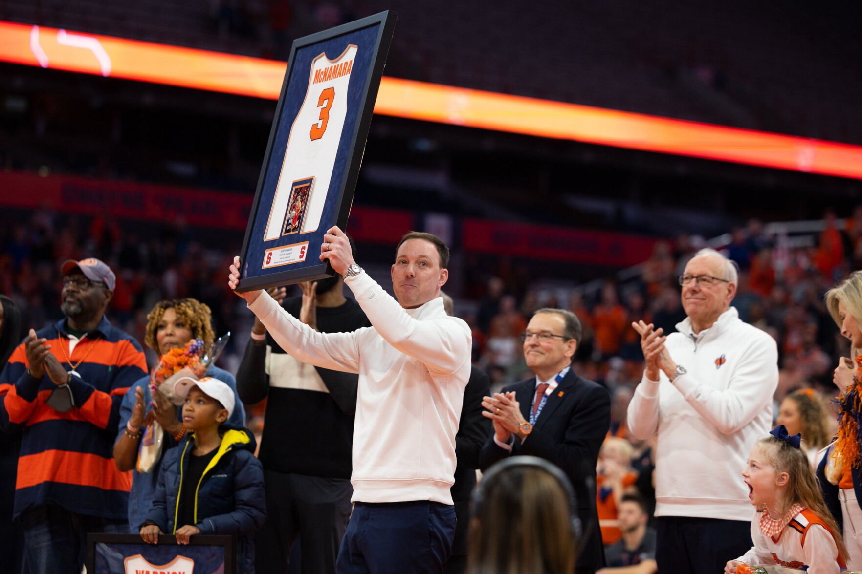 Gerry McNamara holds his framed jersey during a retirement ceremony...