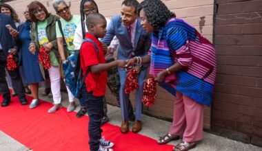 Philadelphia schools Superintendent Tony B. Watlington Sr, center, and Mayor Cherelle L. Parker, greet a student at Edward T. Steel School on the first day of the 2025-26 school year in August. The district is facing steep budget cuts for next school year.