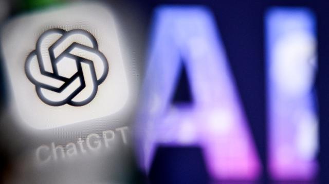 A photo taken on Sept. 1, 2025, shows the letters "AI" for Artificial Intelligence on a laptop screen (right) next to the logo of the ChatGPT application on a smartphone screen in Frankfurt am Main, western Germany. 