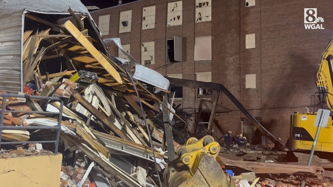 Crews comb through debris at the site of a candy factory explosion in West Reading, Berks County.
