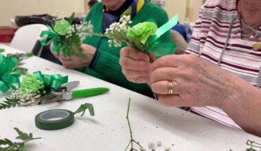 Volunteers assemble shamrock corsages for St. Patrick's Day in Scranton