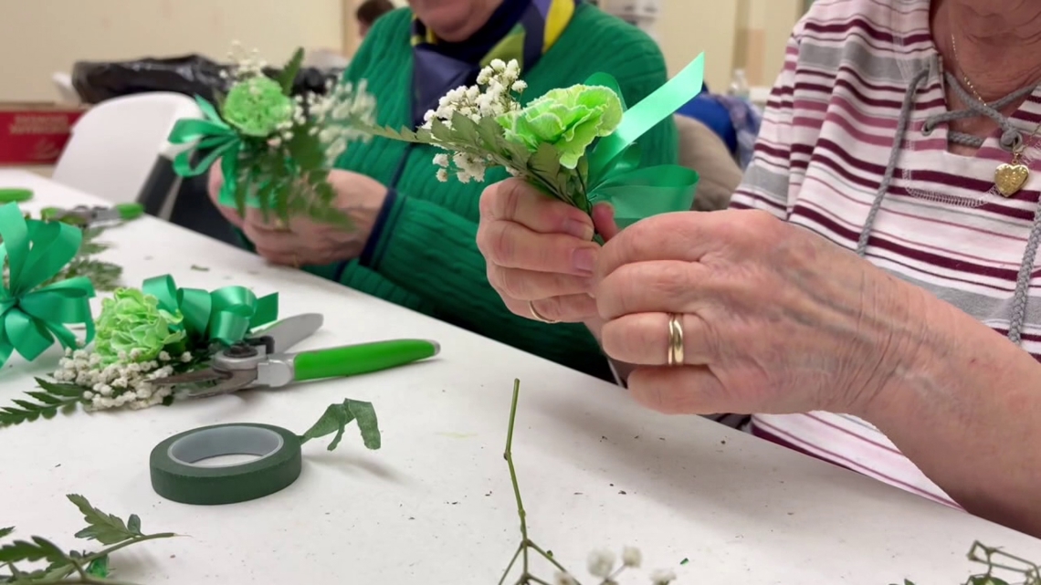 Volunteers assemble shamrock corsages for St. Patrick's Day in Scranton