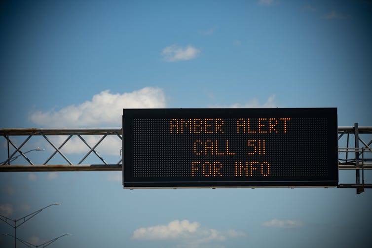 A digital sign with lights that spell out 'Amber Alert Call 511 for Info'