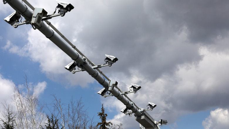 Close up of a toll collection system setup above a highway with cameras visible.