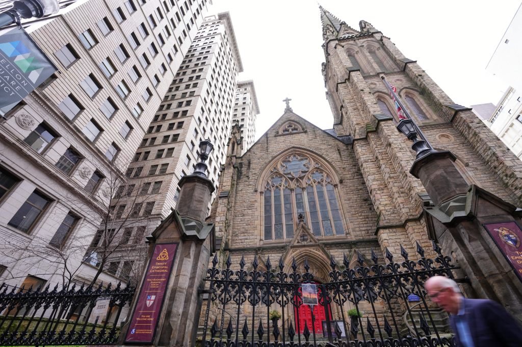 Trinity Episcopal Cathedral in downtown Pittsburgh with a person walking past it.