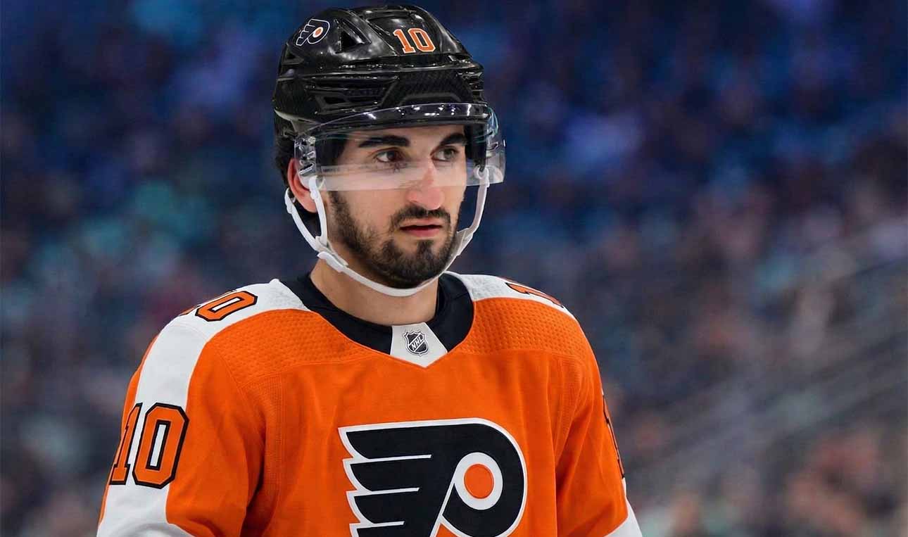A photo visualization of Seattle Kraken center Matty Beniers wearing a Philadelphia Flyers orange home jersey, representing ongoing NHL trade rumors and speculative scenarios linking the two teams.