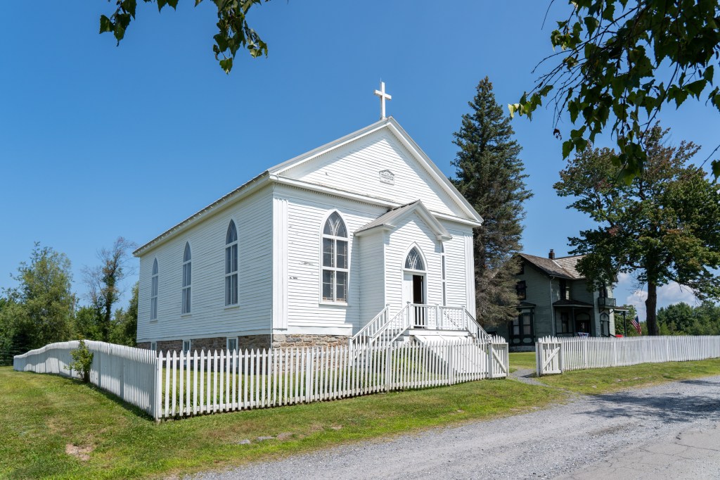 Historic white church with a picket fence in Eckley Miners Village, Pennsylvania.