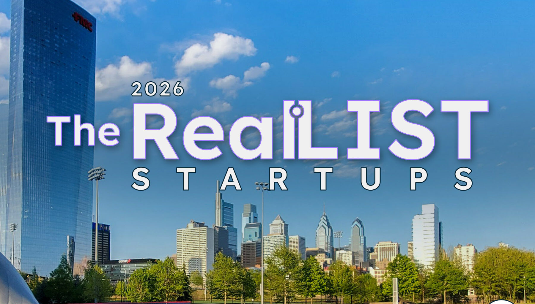 A city skyline with skyscrapers rises behind a softball field. Text in the sky reads "2026 The RealLIST STARTUPS" with a logo in the lower right corner.