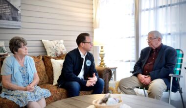 Pennsylvania Governor Josh Shapiro seated, speaking with a family at a manufactured housing community in Berks County