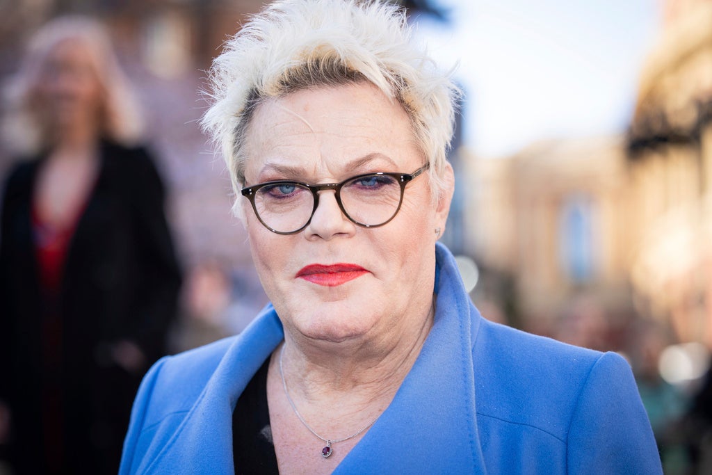 Suzy Eddie Izzard poses for photographers upon arrival at the Olivier Awards