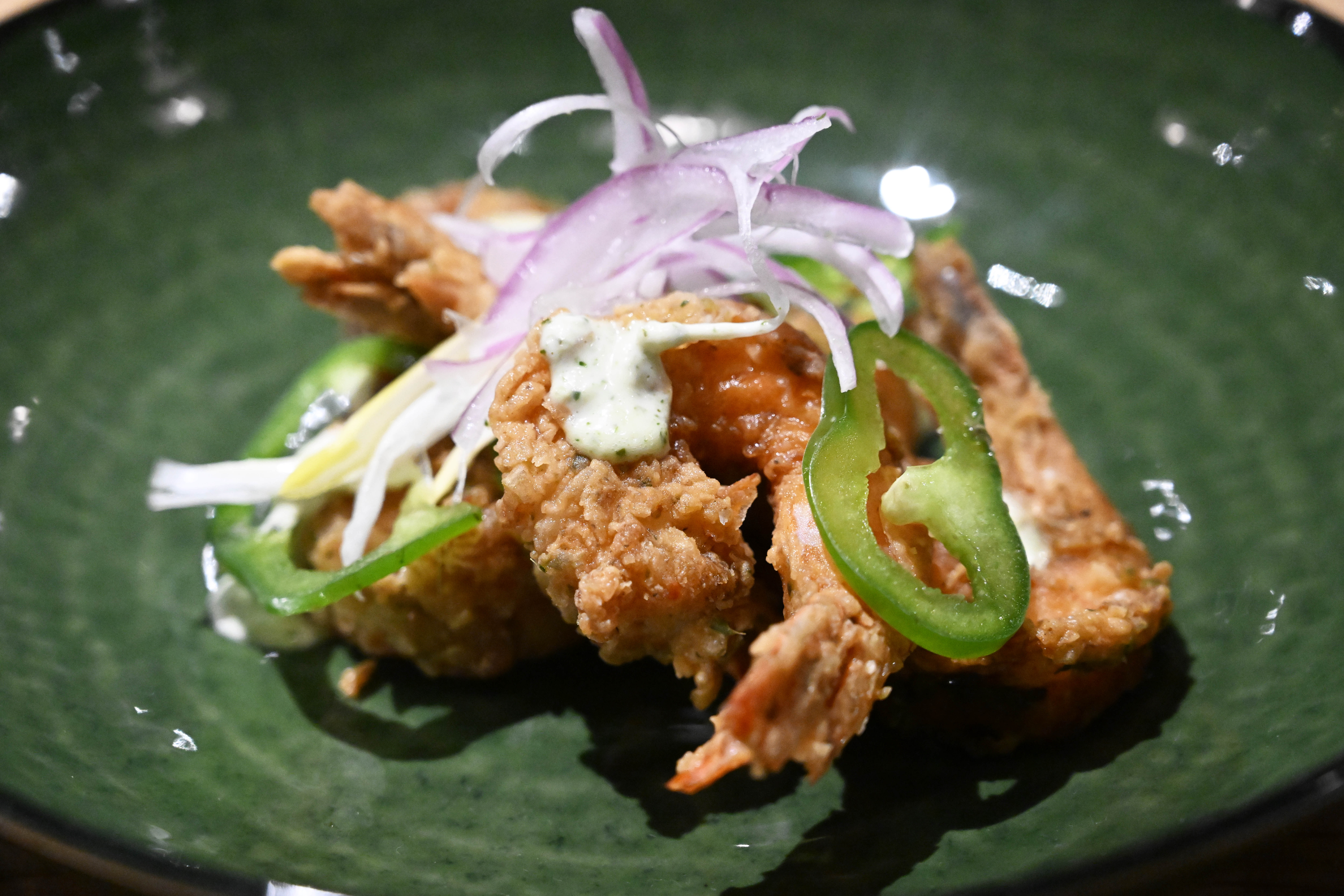 Dish green seasoning shrimp is seen Wednesday, March 18, 2026,...