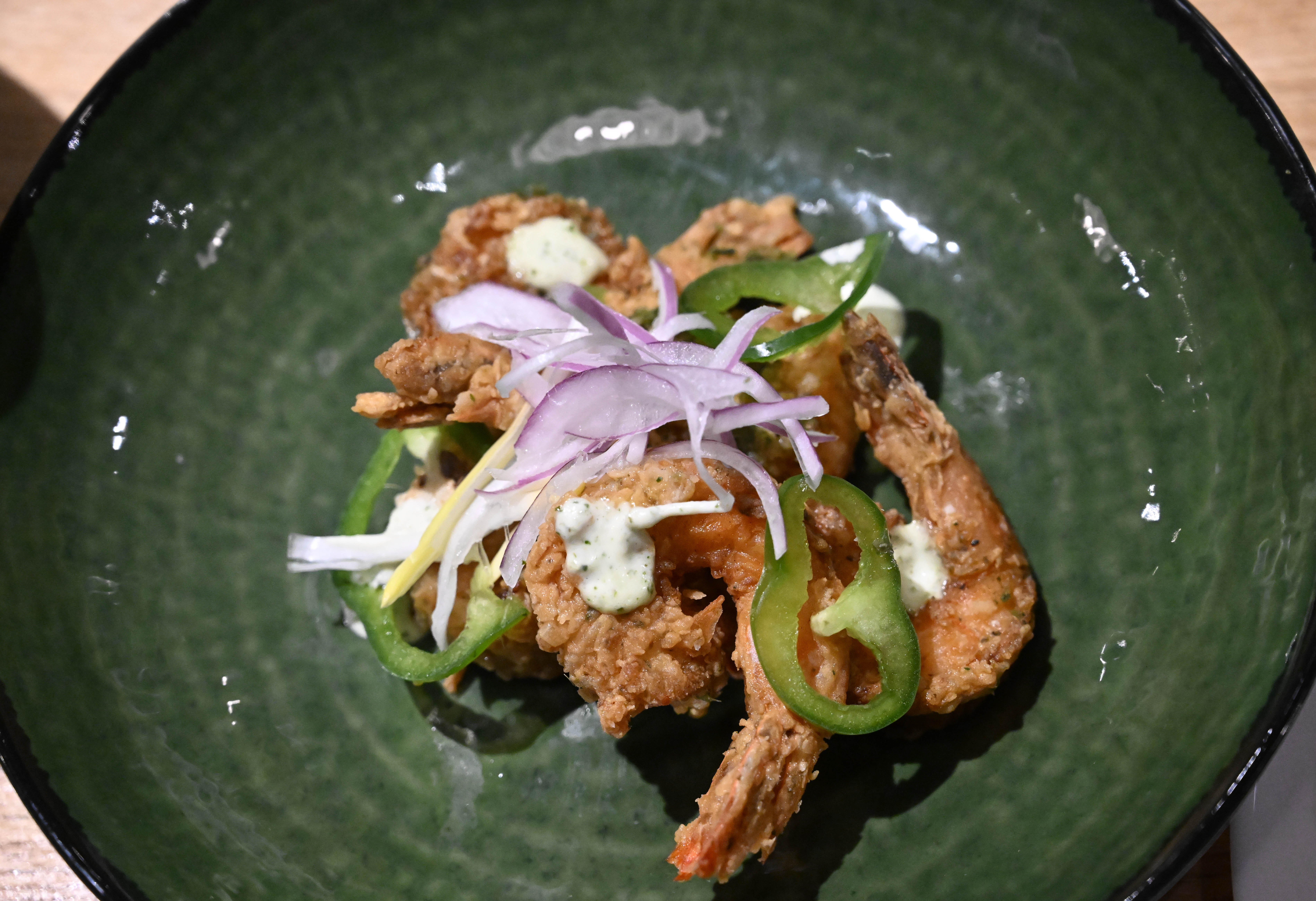 Dish green seasoning shrimp is seen Wednesday, March 18, 2026,...