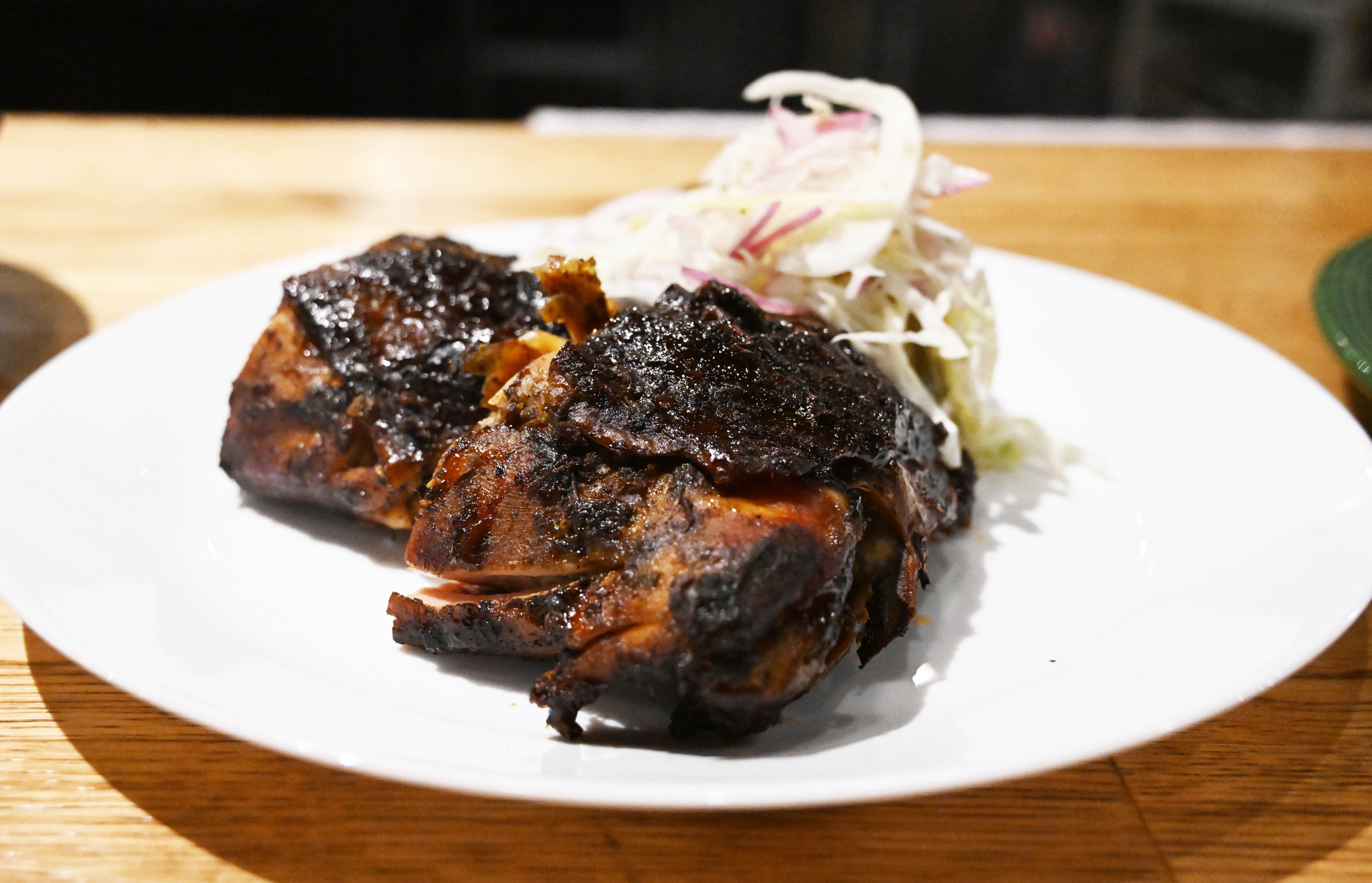 Dish smoked jerk chicken is seen Wednesday, March 18, 2026,...