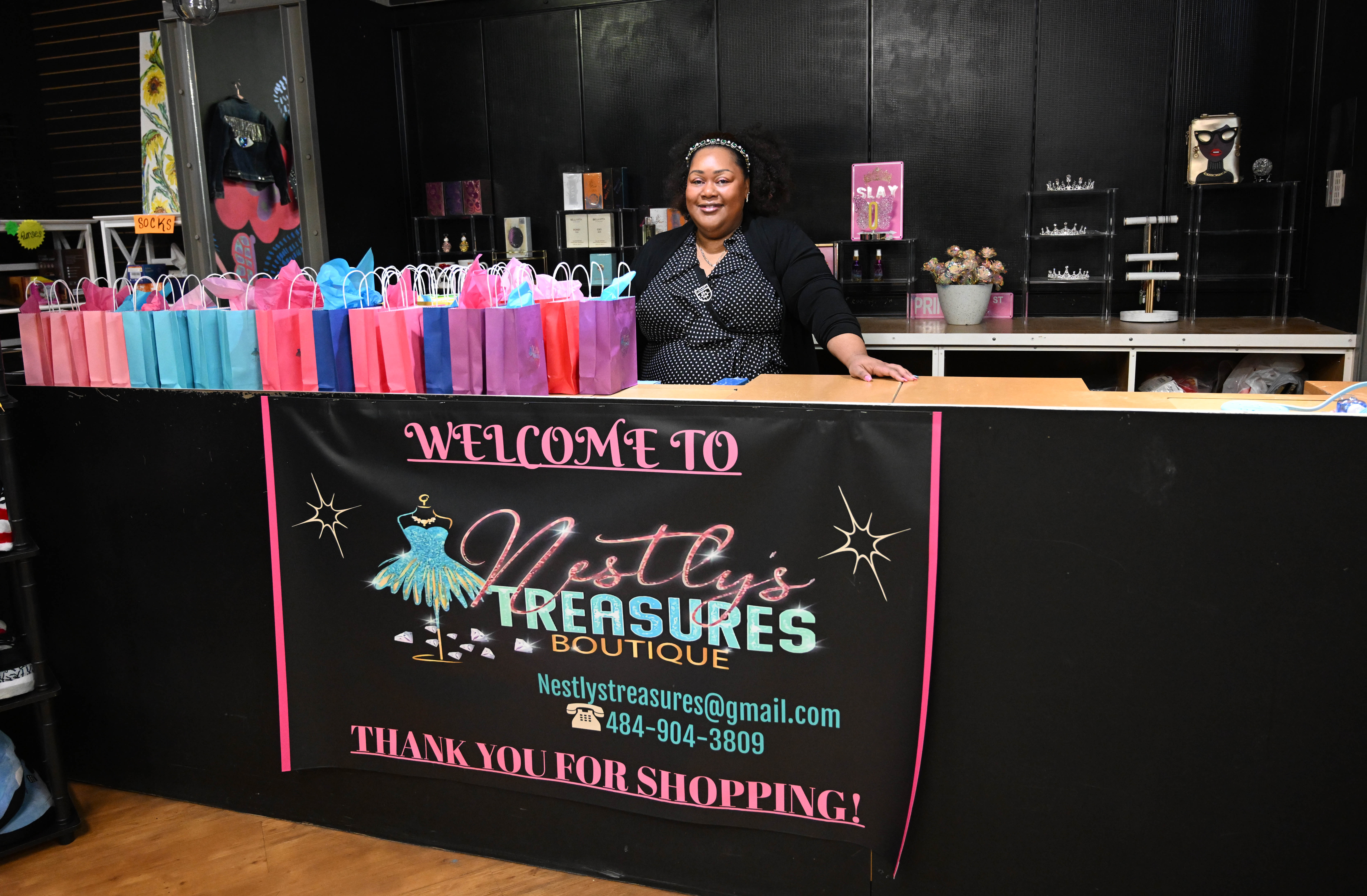 Vanessa Prince, the owner of Nestly’s Treasures Boutique, stands at...