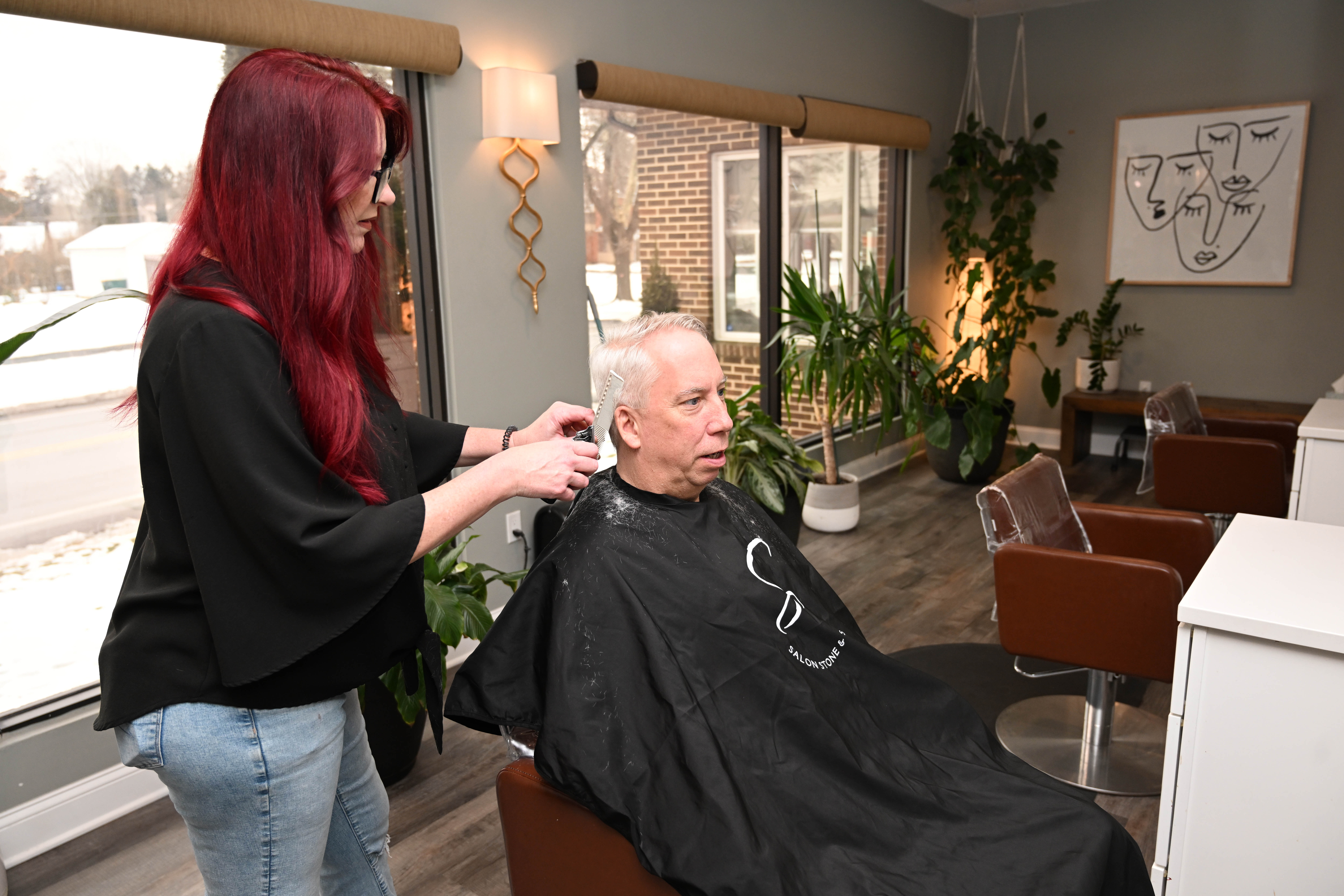 Manager Laura Davis gives a haircut to Dave Hauck Wednesday,...