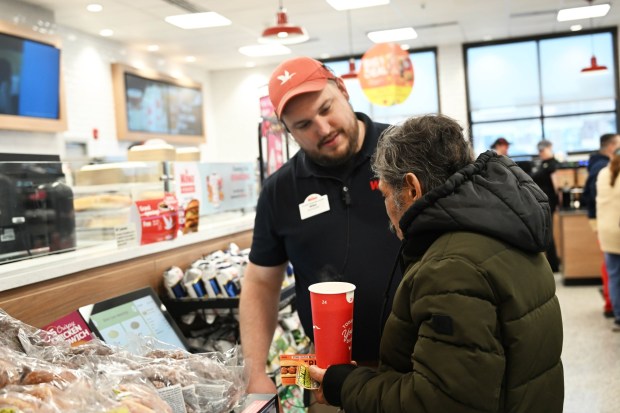 Mike Chisholm, the general manager of the new Wawa, greets customers Thursday, March 12, 2026, during the store's grand opening in Whitehall Township. (Amy Shortell/The Morning Call)
