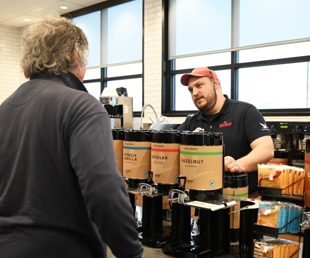 Mike Chisholm, the general manager of the new Wawa, greets customers Thursday, March 12, 2026, during the store's grand opening in Whitehall Township. (Amy Shortell/The Morning Call)