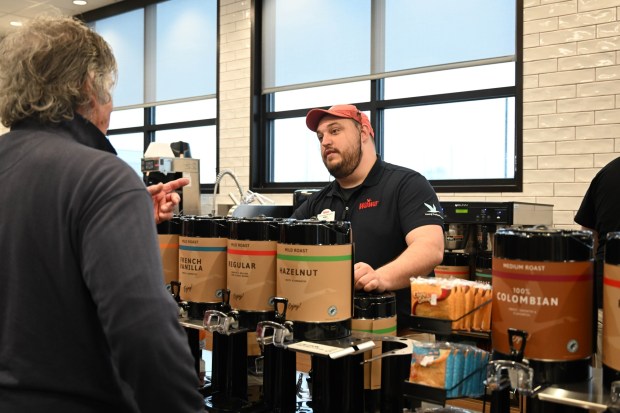 Mike Chisholm, the general manager of the new Wawa, greets customers Thursday, March 12, 2026, during the store's grand opening in Whitehall Township. (Amy Shortell/The Morning Call)
