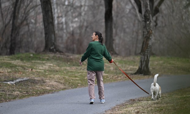 Rosemary Reppert walks her dog, Jethro, on Wednesday, March 11, 2026, on the Irontron Rail Trail near the Saylor Park cement kilns in Coplay. (Amy Shortell/The Morning Call)