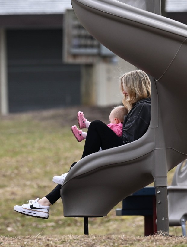 Alivea Foloweiler and her daughter, Ellie DeRosa, enjoy a slide Wednesday, March 11, 2026, at Saylor Park in Coplay. (Amy Shortell/The Morning Call)