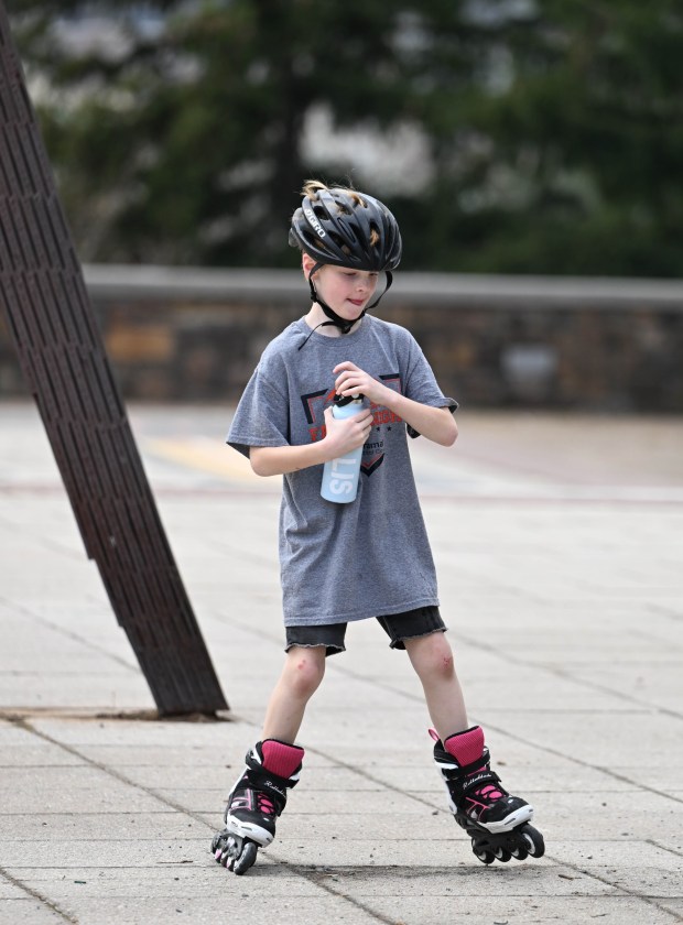 Ellis White, 7, takes a drink while rollerblading Wednesday, March 11, 2026, at Payrow Plaza in Bethlehem. (Amy Shortell/The Morning Call)