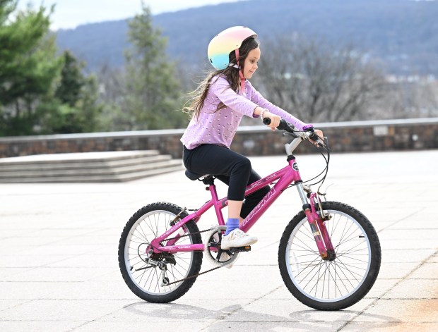 Amelie Lowcher, 8, rides her bike Wednesday, March 11, 2026, at Payrow Plaza in Bethlehem. (Amy Shortell/The Morning Call)