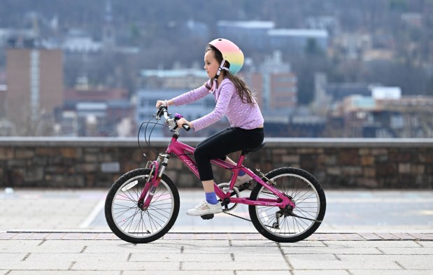 Amelie Lowcher, 8, rides her bike Wednesday, March 11, 2026, at Payrow Plaza in Bethlehem. (Amy Shortell/The Morning Call)