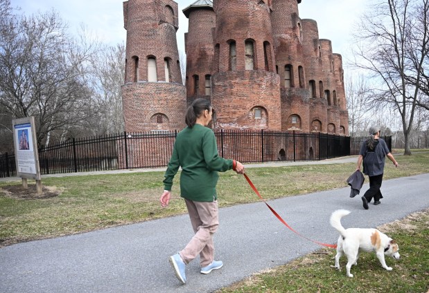 Rosemary Reppert walks her dog, Jethro, on Wednesday, March 11, 2026, on the Irontron Rail Trail near the Saylor Park cement kilns in Coplay. (Amy Shortell/The Morning Call)