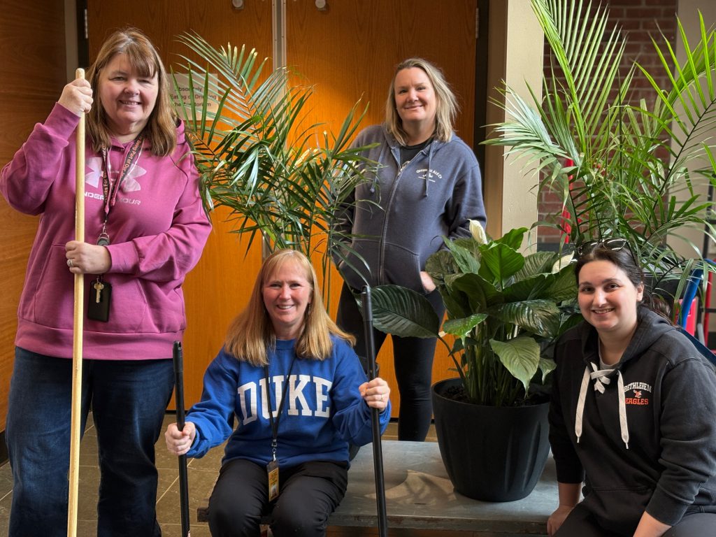 group holding gardening tools