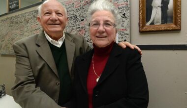 In this Dec. 4, 2019, file photo, restaurant owners Stephen Paliouras and wife Nina are shown at New York Lunch on East Avenue in Erie. The couple has owned and operated the restaurant for 50 years at that point. Behind them is their wedding photo from 1965.