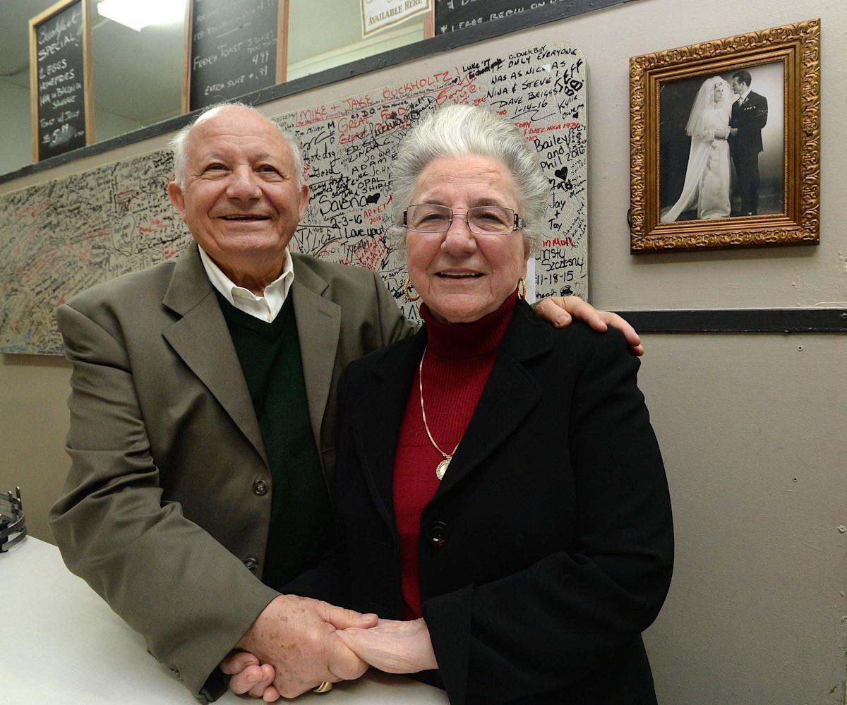 In this Dec. 4, 2019, file photo, restaurant owners Stephen Paliouras and wife Nina are shown at New York Lunch on East Avenue in Erie. The couple has owned and operated the restaurant for 50 years at that point. Behind them is their wedding photo from 1965.