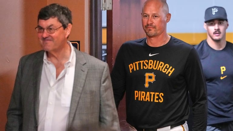 Pittsburgh Pirates' Konnor Griffin, right, follows manager Don Kelly, center,...