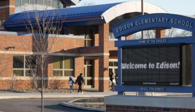Edison Elementary School third-grade student Elijah Santiago-Rodriguez enters the new building for the first time, after Easter break and on crutches, in Erie, Pa.