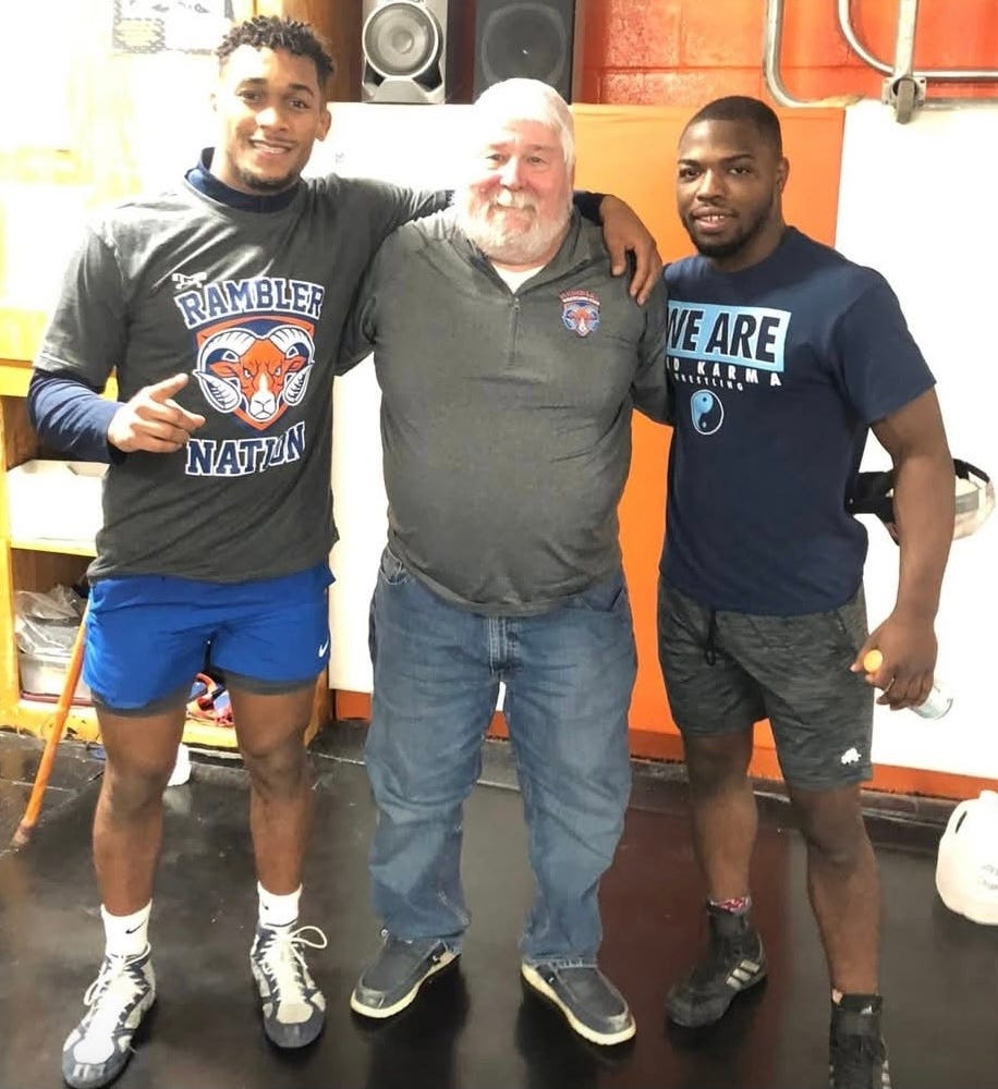 Floyd “Skip” Chatt (center) is pictured with former Cathedral Prep wrestlers Carter Starocci (left) and Paniro Johnson (right) in the Prep wrestling room. Starocci and Johnson both enjoyed NCAA Division I success after starting their careers under Chatt.