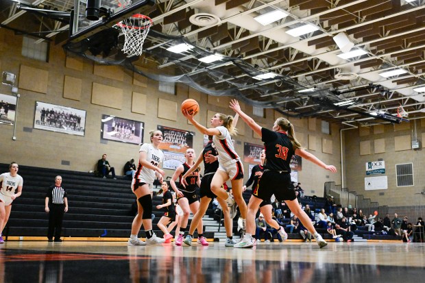 Erie's Juliet Slater, center, shoots between Skyline's Lauren Pratt, left, and Breanne Baker, right, on Tuesday, Jan. 28, 2025. (Matthew Jonas/Staff Photographer)